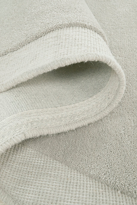 Close-up of a textured light gray fabric with a subtle pattern.