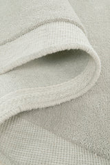 Close-up of a textured light gray fabric with a subtle pattern.