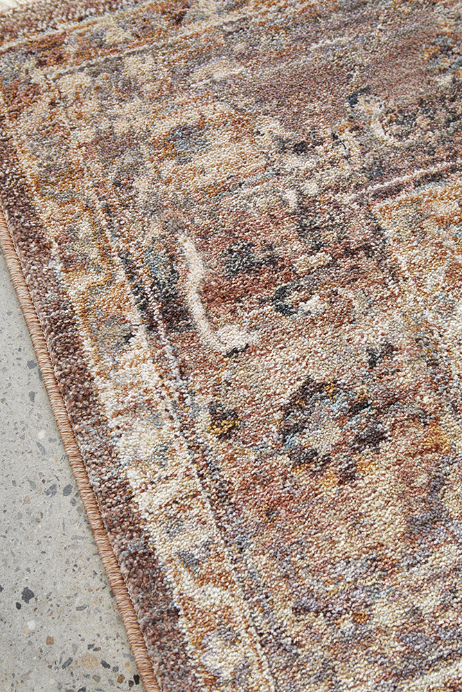 Close-up of a textured area rug with a geometric pattern on a concrete floor.